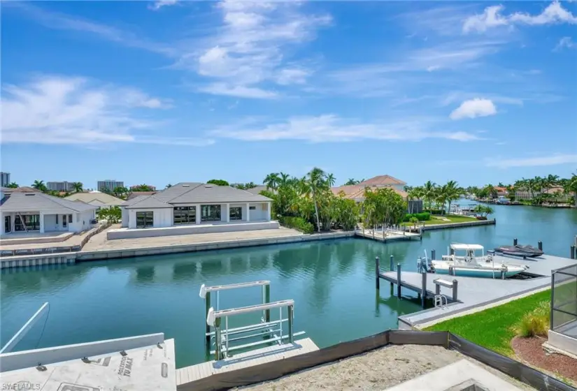 View of dock featuring a water view and a pool