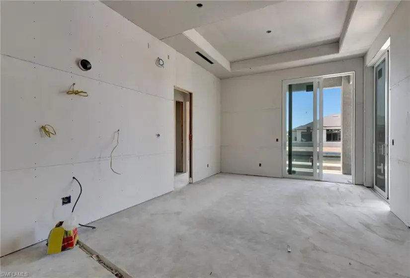 Unfurnished room featuring a tray ceiling