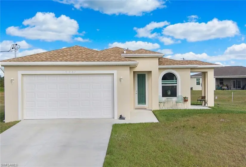 View of front of house with a garage and a front lawn