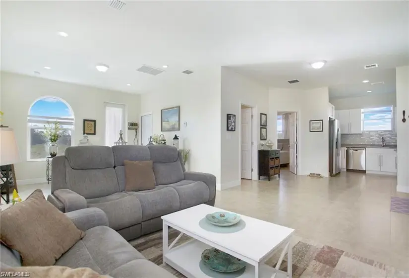 Living room with sink and light tile floors