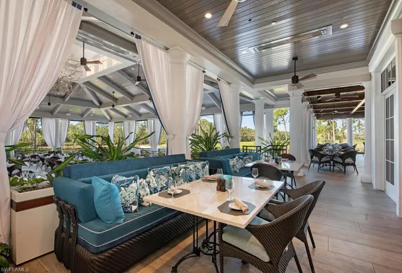 Sunroom featuring ceiling fan, a healthy amount of sunlight, and ornate columns