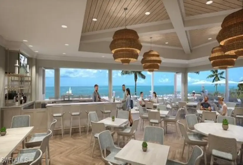 Dining area with ornamental molding, an inviting chandelier, a water view, light parquet floors, and coffered ceiling