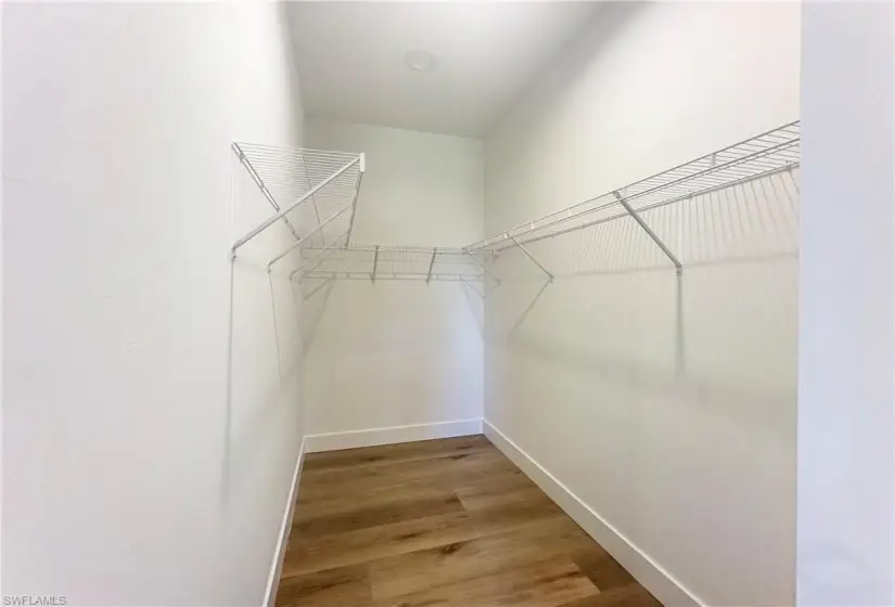 Spacious master closet featuring wood-type flooring